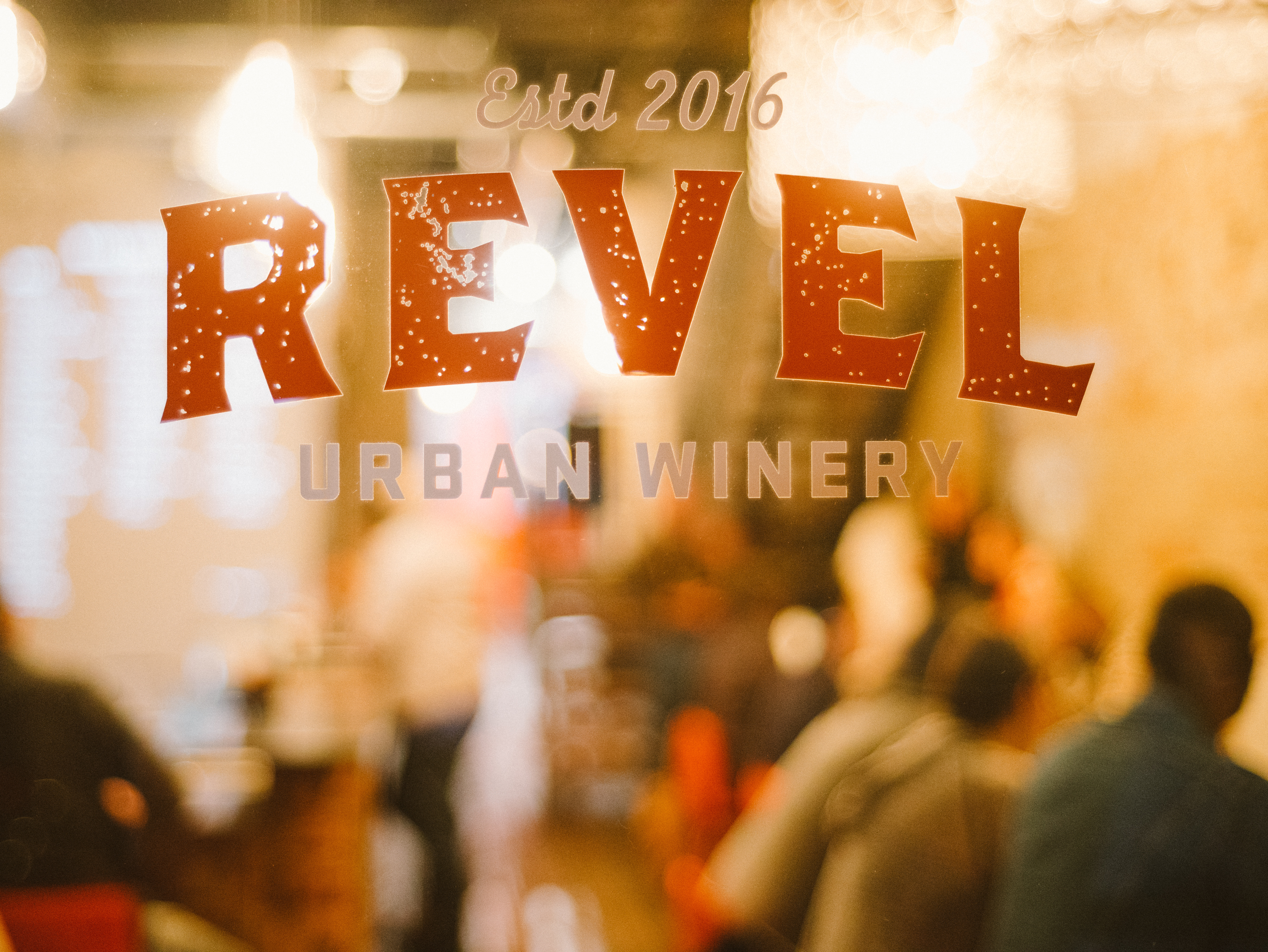 Revel Urban Winery front glass with the taproom visible behind